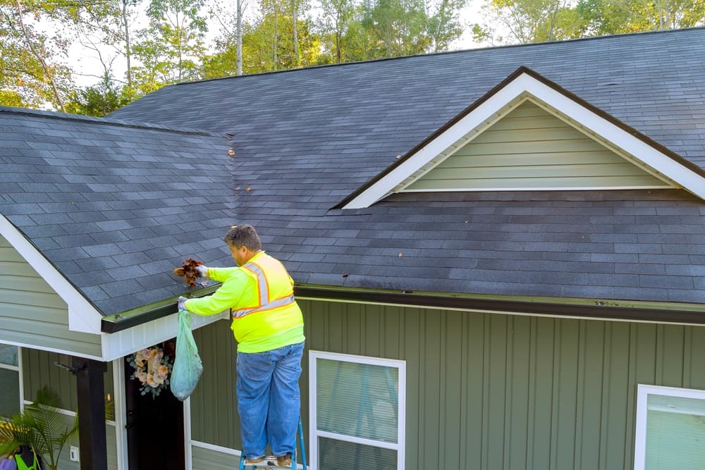 roof-gutter-cleaning-service-worker-unclogging